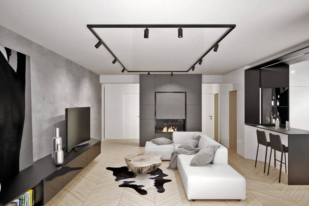 Obývačka bytu v čierno- bielych tónoch doplnená o útulnú drevenú podlahu